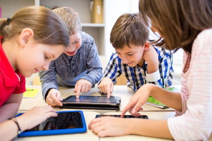 This image has an empty alt attribute; its file name is Kids-Using-iPads.jpg